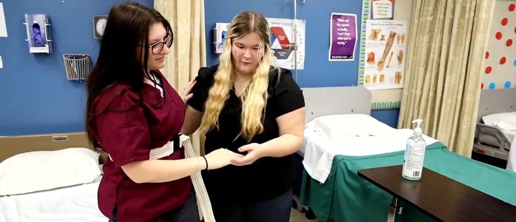 HA student helping a patient