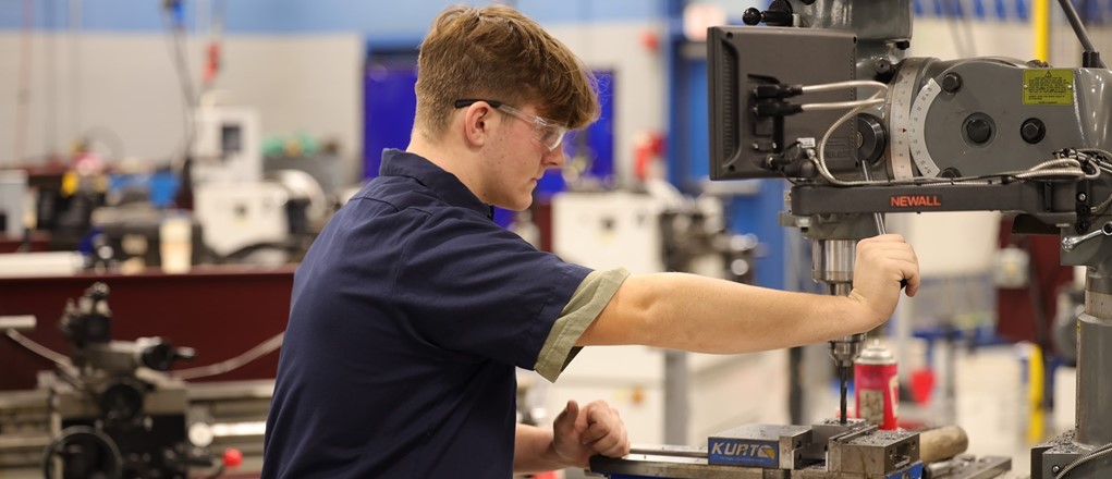 PMM Student using a machine