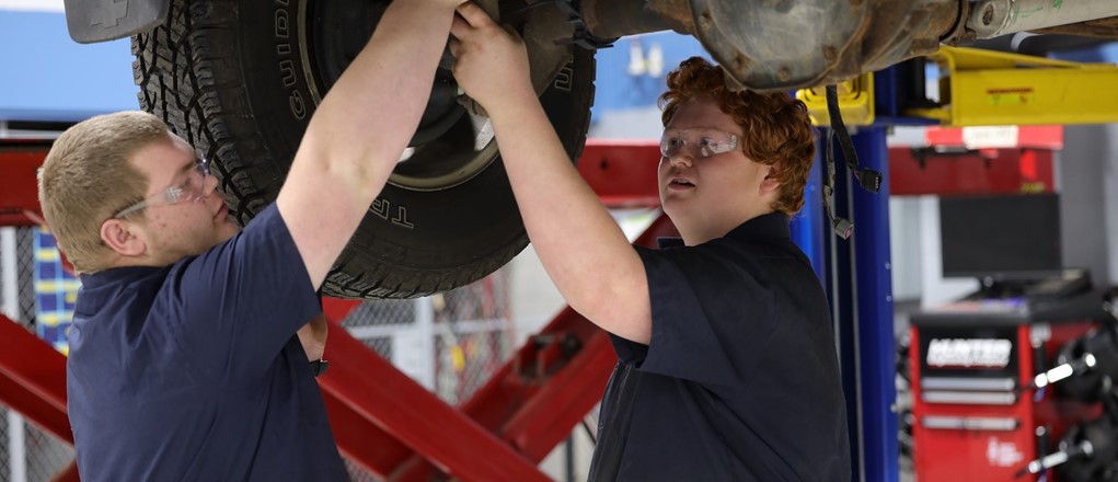 AT students working under a car